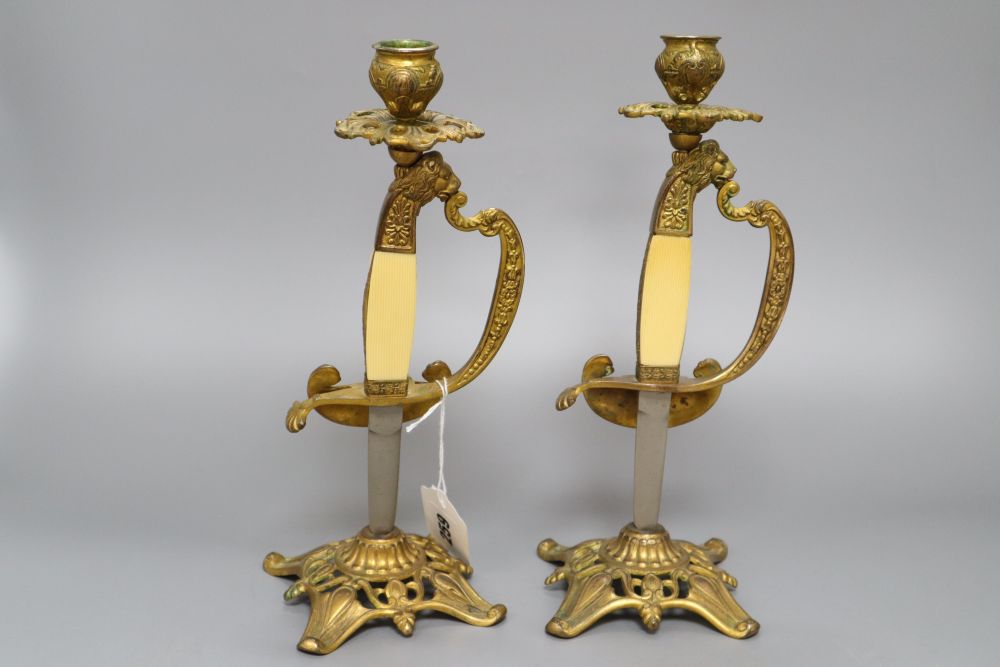 A pair of gilt metal and ivorine sword hilt candlesticks, height 28cm